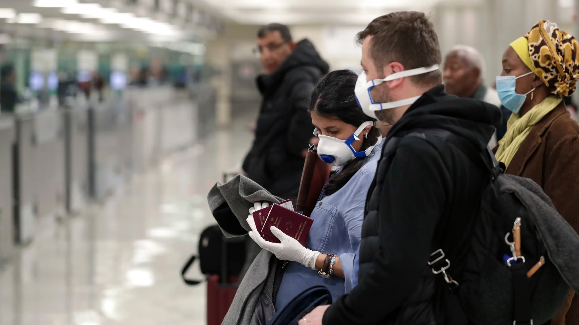 International travelers arrive at Dulles International Airport on March 18, 2020.