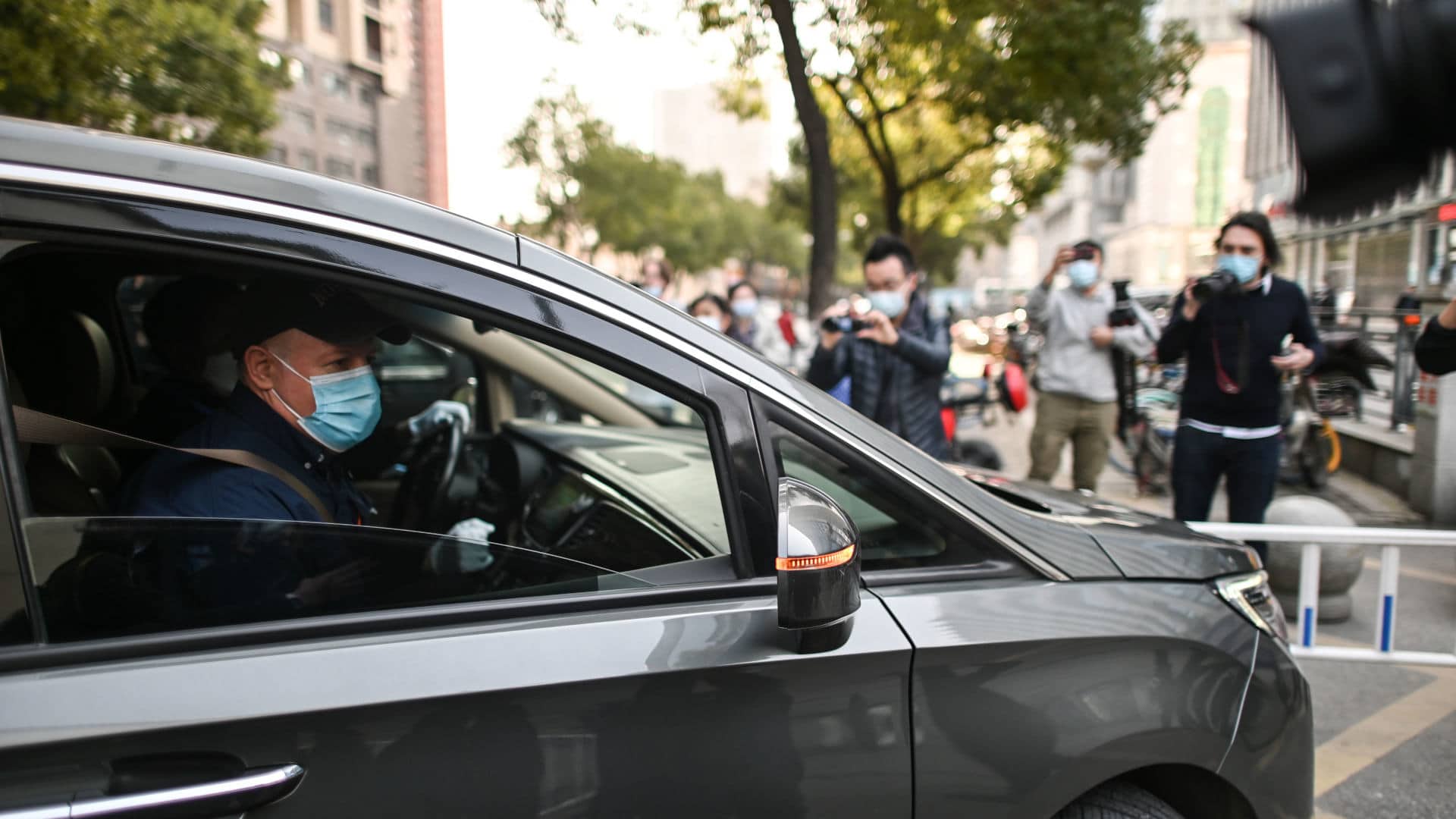 Peter Daszak (in vehicle) and other members of the WHO team investigating the origins of Covid-19 arrive at Xinhua Hospital in Wuhan, China, January 29, 2021.